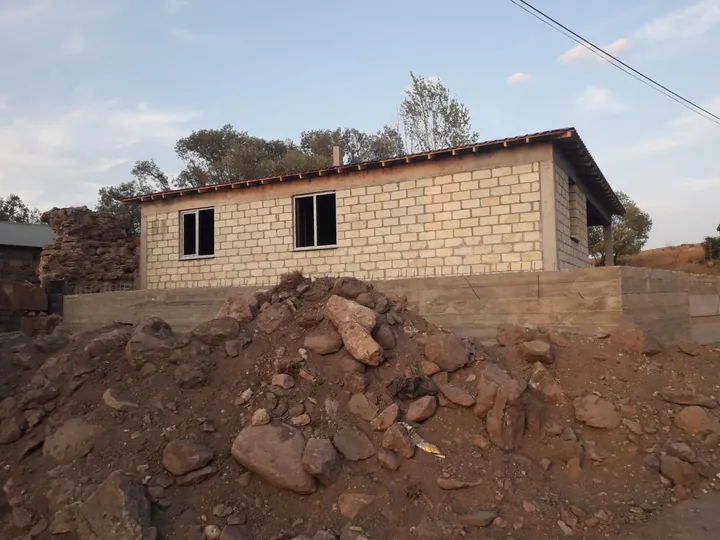 Çatı örtüsü bulunan tek katlı yapının blok duvarları ve şantiye görünümü